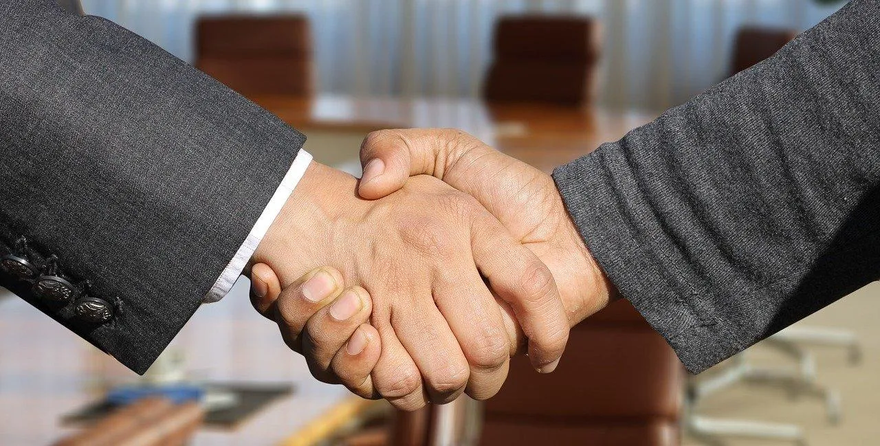 Business negotiation handshake